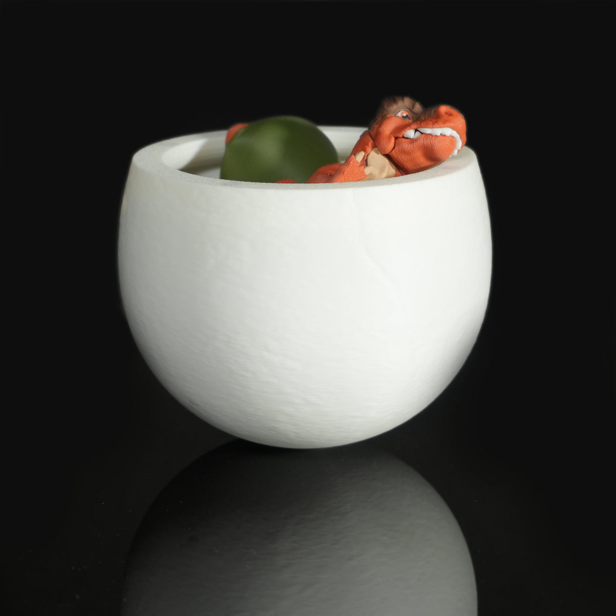 Open dino egg with small dinosaur figures tucked inside