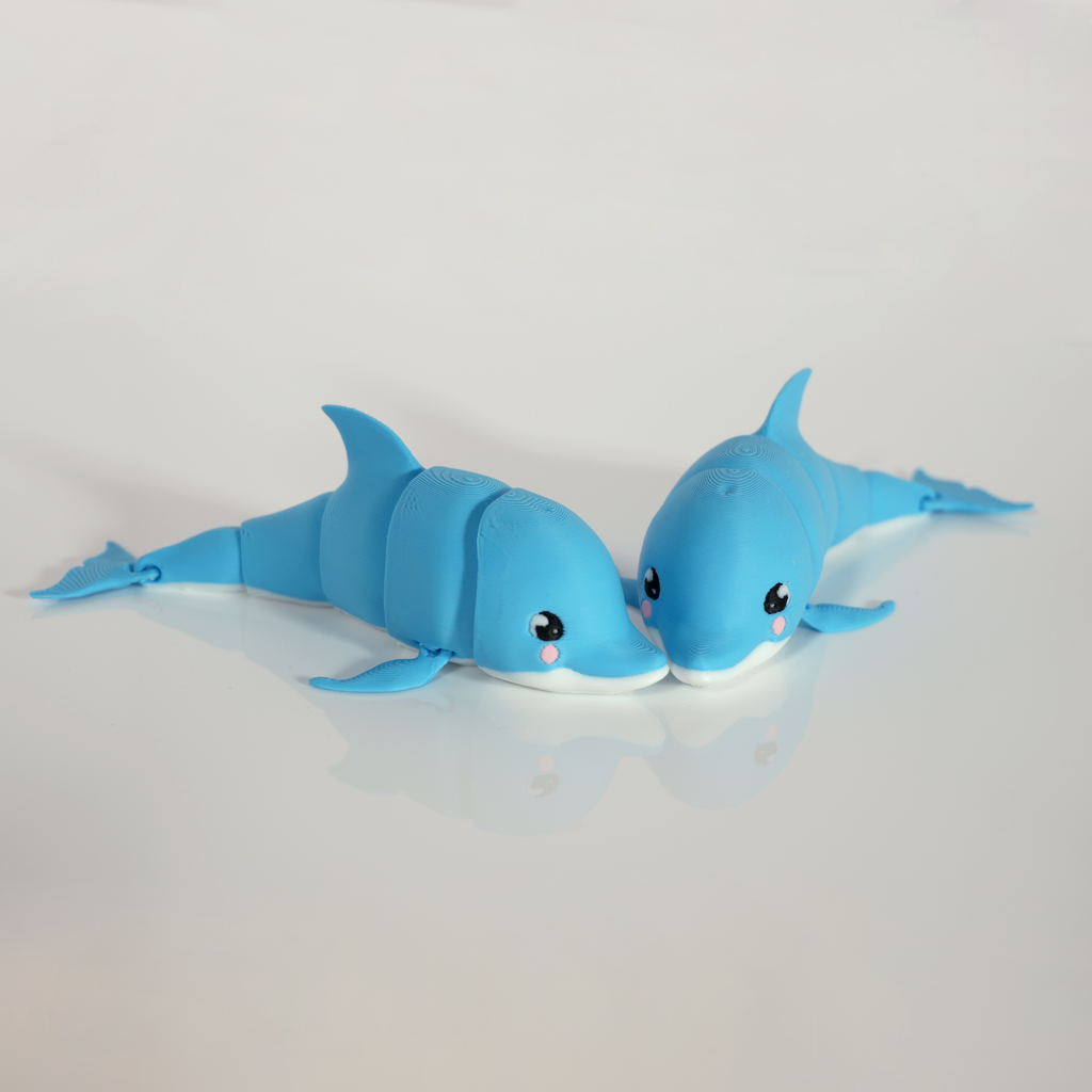 Two blue articulated dolphins side by side, nose to nose