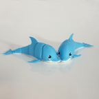 Two blue articulated dolphins side by side, nose to nose
