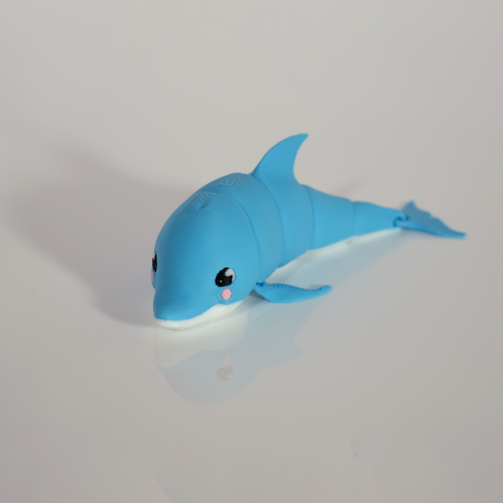 Blue articulated kawaii dolphin 3D print with a white belly and pink cheeks