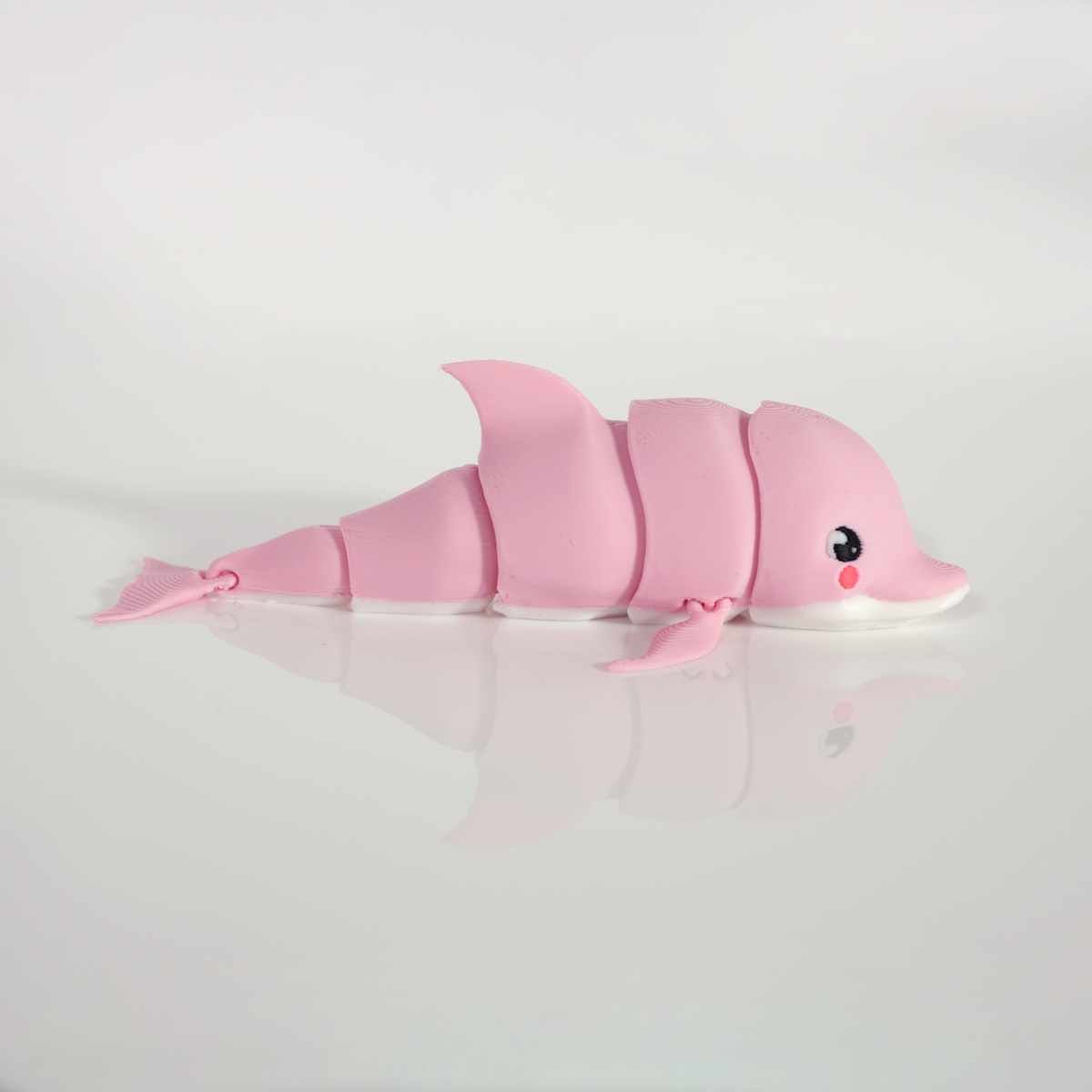 Side view of the pink dolphin showing its articulated body segments