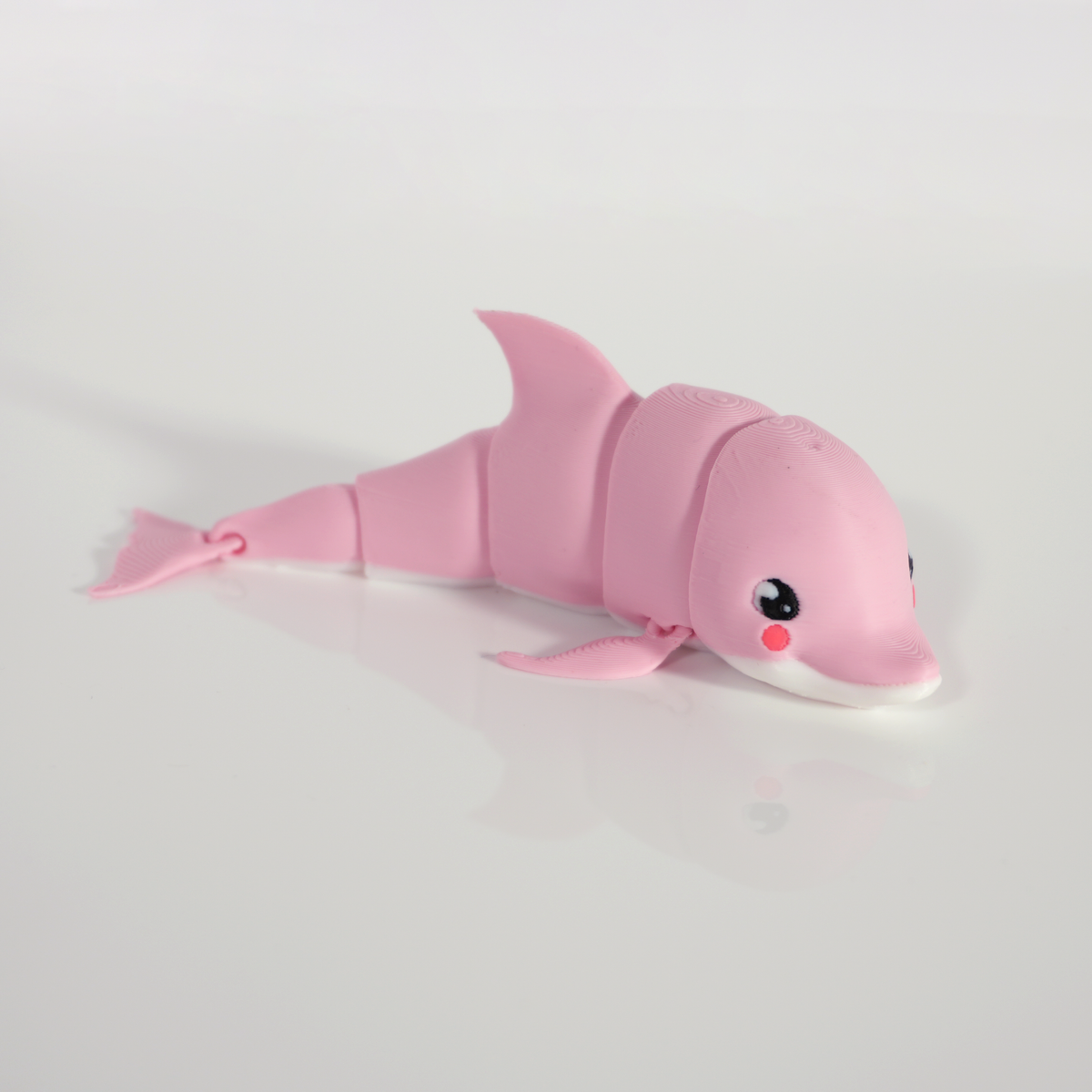 Pink articulated dolphin curving to the side