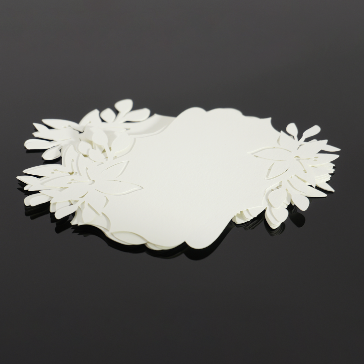 Stack of Lily lace-cut paper pieces with layered flower cutouts
