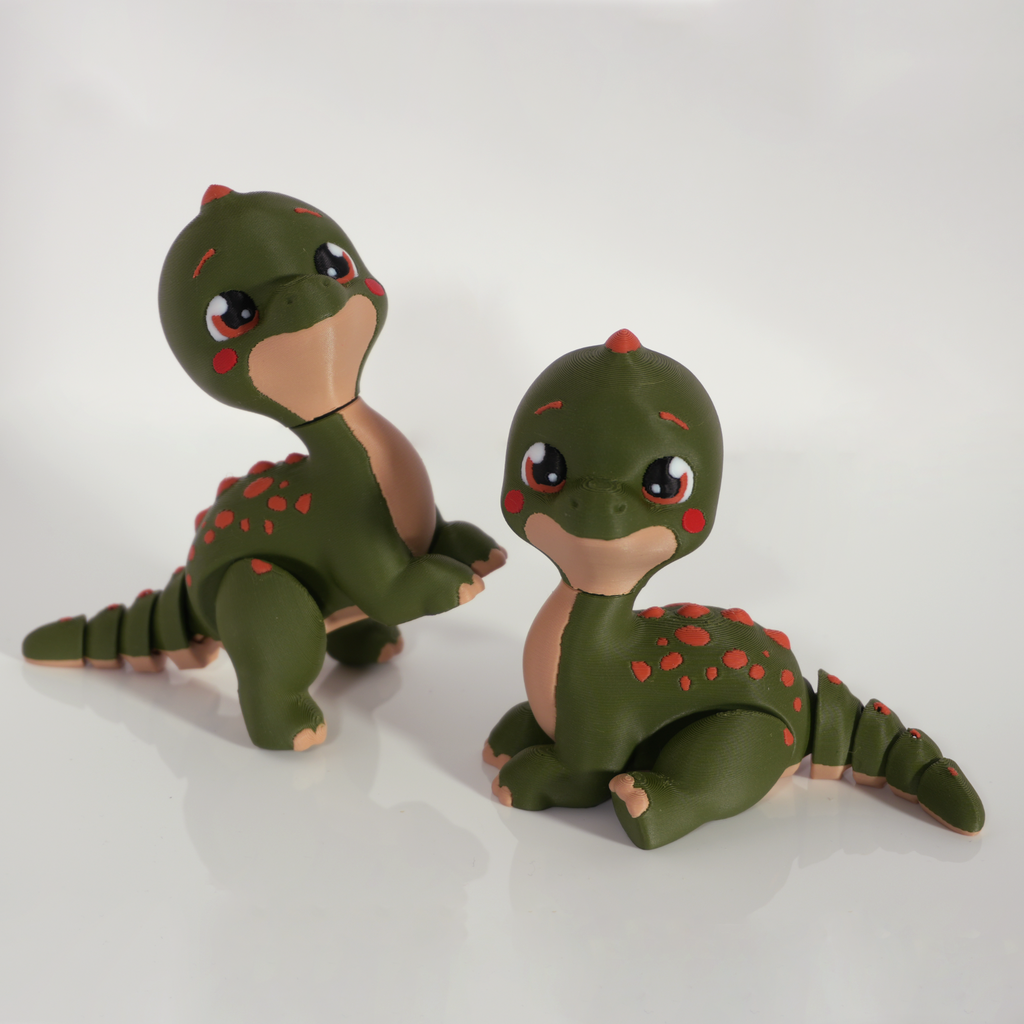 Two Tiny Diny dinosaurs, one rearing up and one sitting