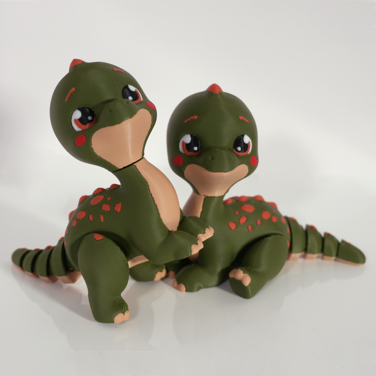 Two articulated Tiny Diny dinosaurs posed together