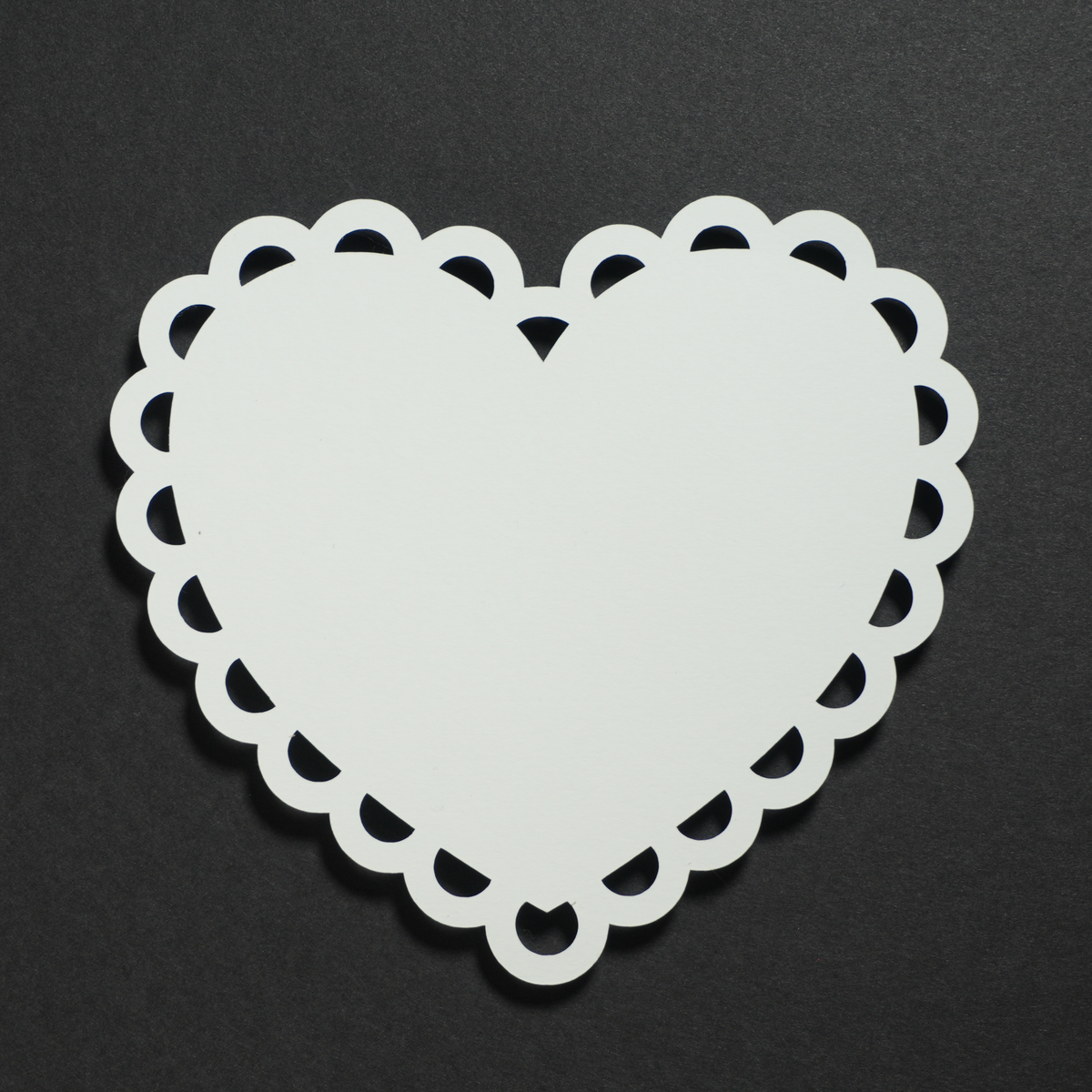Lace Heart: a white heart-shaped paper with a scalloped lace edge