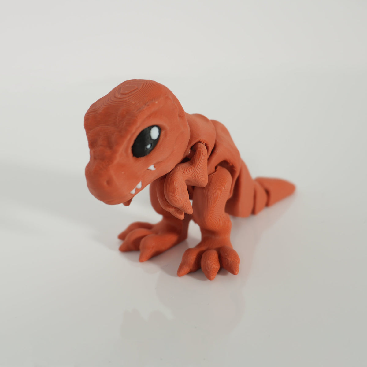 Tiny T-Rex: orange articulated kawaii T-rex 3D print with big glossy eyes