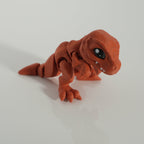 Tiny T-Rex crouching low, showing its articulated legs and tail