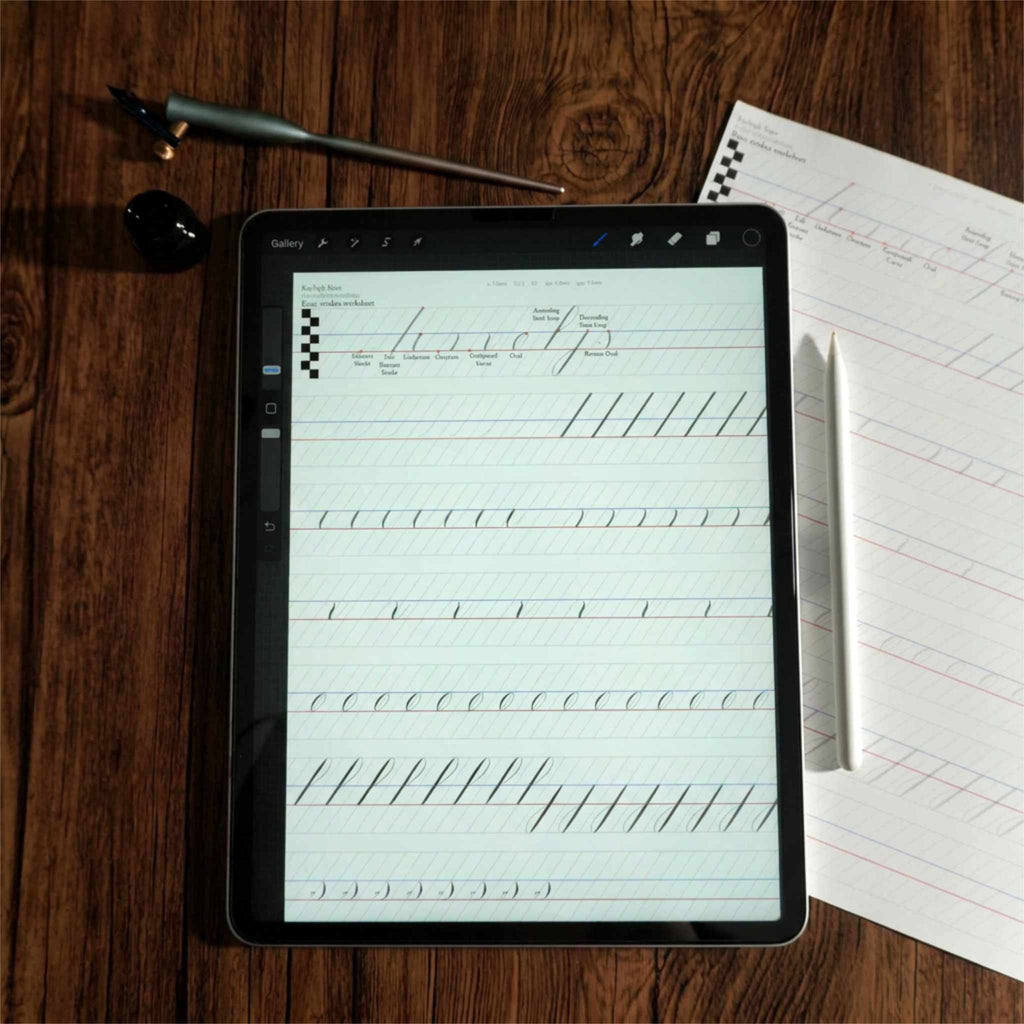 Basic strokes calligraphy worksheet in Procreate on an iPad, beside a printed copy and a dip pen