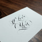 Close-up of "I Love You" in pointed-pen copperplate calligraphy with flourishes